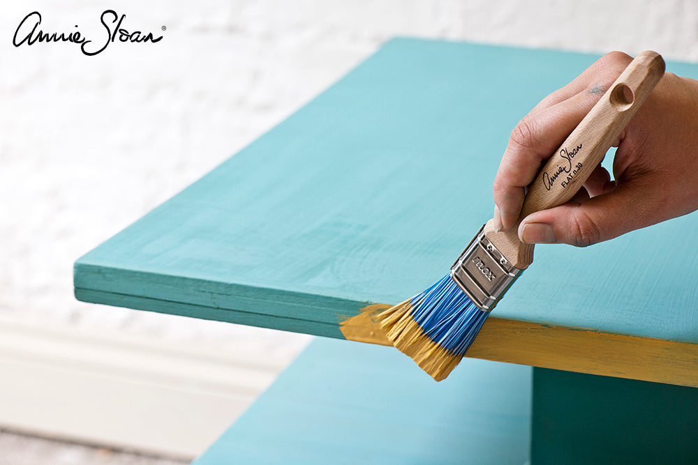 Applying Chalk Paint® decorative paint to a painted table
