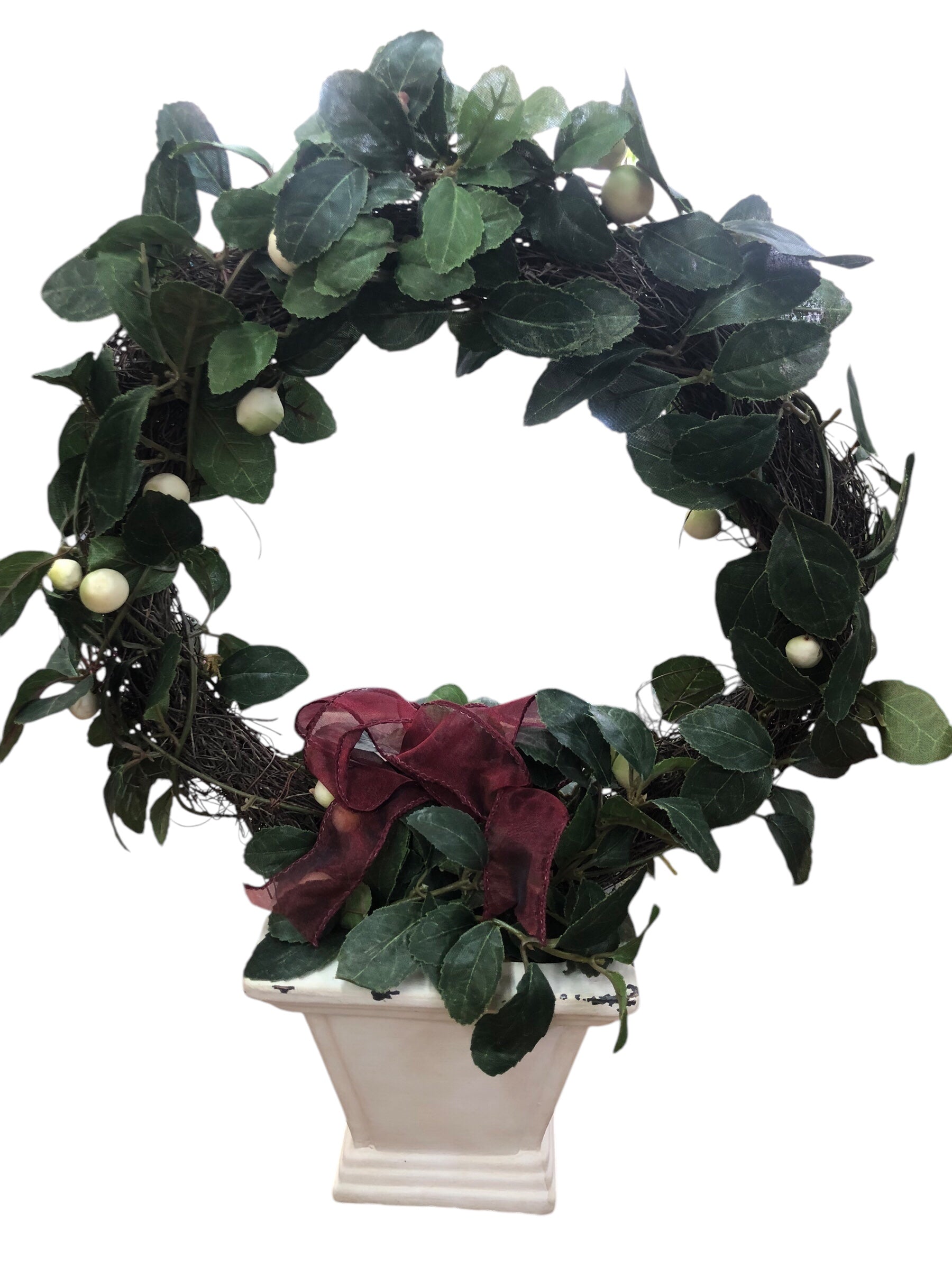 Wreath in white pot/green leaves/cream berries