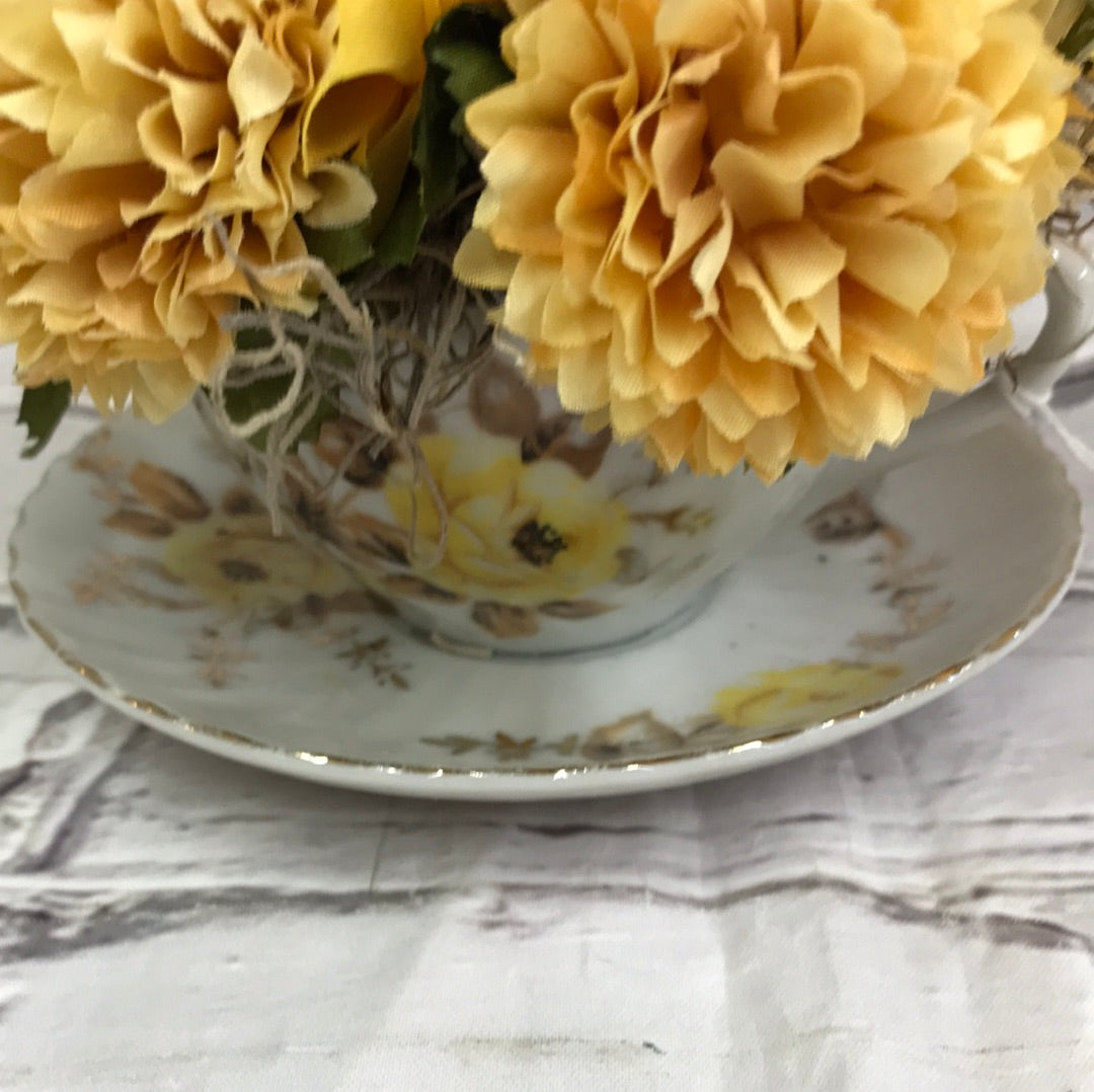 Teacup with yellow flowers